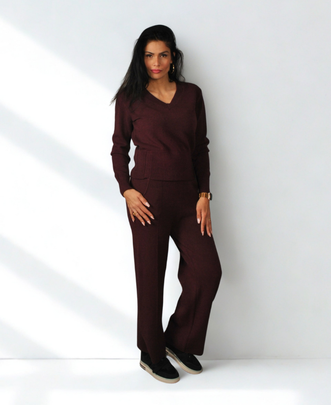 
                      
                        Model draagt warme knit set met V-hals trui en rechte broek in Italiaanse stijl – Donna Colori.
                      
                    